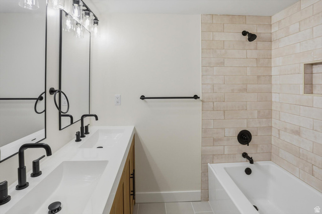 810 East Maple Street Mapleton, UT 84664 - Photo 25 of 49 Modern bathroom featuring a dual vanity with integrated sinks, matte black fixtures, and wood-finish cabinetry