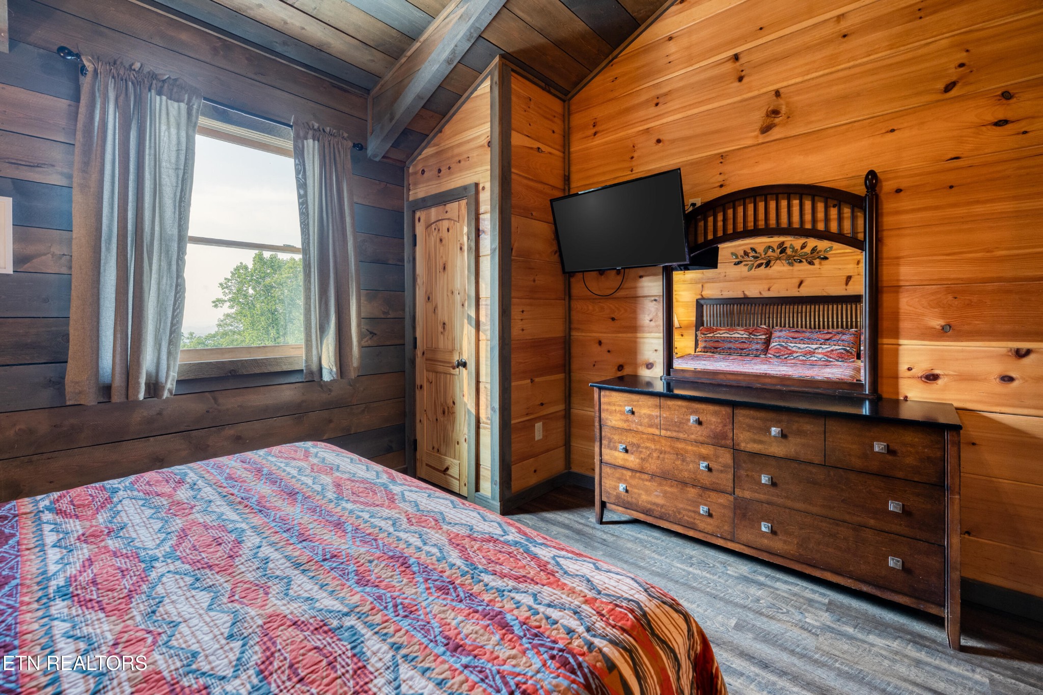 809 Pinecrest Way Sevierville, TN 37862 - Photo 44 of 60 a bedroom with a bed and a dresser next to a window