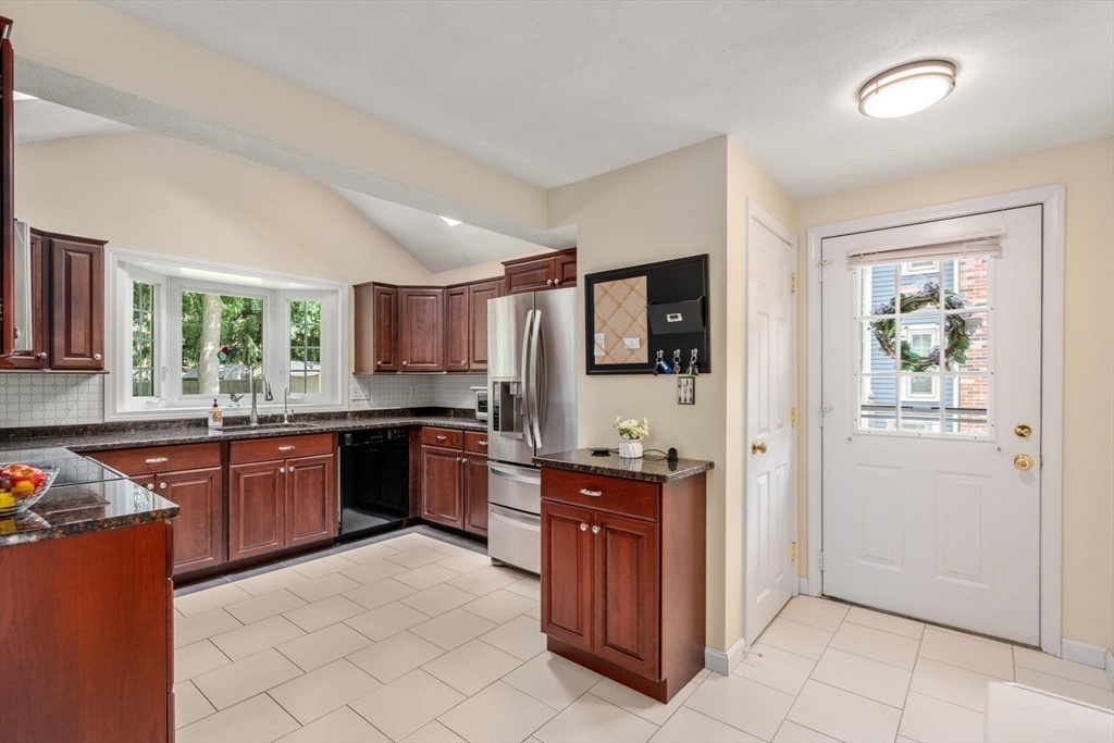 27 Prospect Avenue Arlington, MA 02476 - Photo 19 of 42 a kitchen with stainless steel appliances granite countertop a refrigerator and a stove top oven