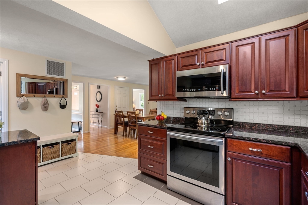 27 Prospect Avenue Arlington, MA 02476 - Photo 21 of 42 a kitchen with granite countertop a stove top oven microwave and cabinets