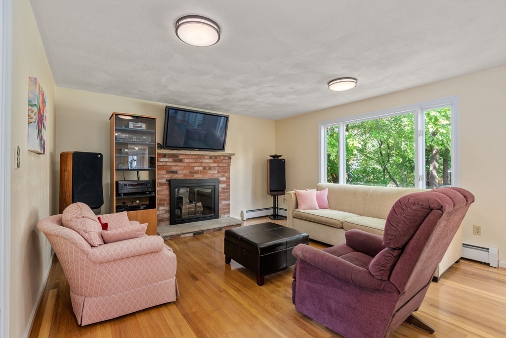 27 Prospect Avenue Arlington, MA 02476 - Photo 24 of 42 a living room with furniture a large window and a fireplace