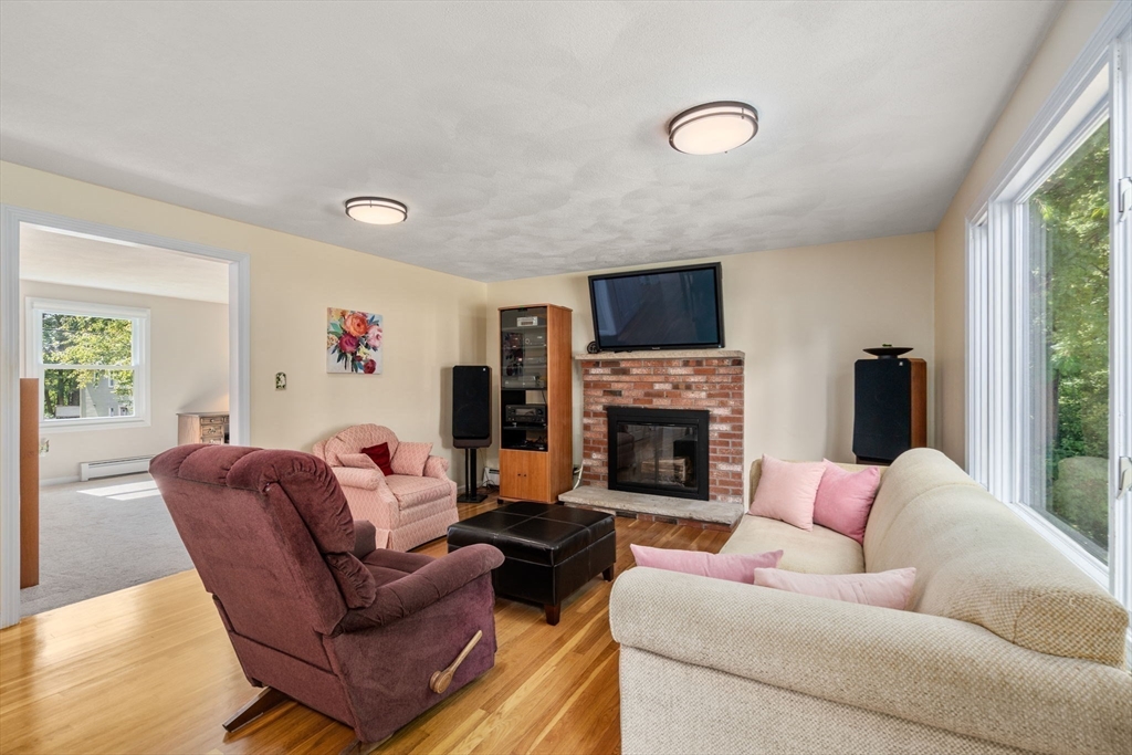 27 Prospect Avenue Arlington, MA 02476 - Photo 25 of 42 a living room with furniture a fireplace and a flat screen tv