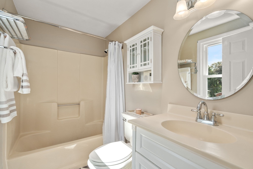 27 Prospect Avenue Arlington, MA 02476 - Photo 30 of 42 a bathroom with a granite countertop sink toilet a mirror and shower