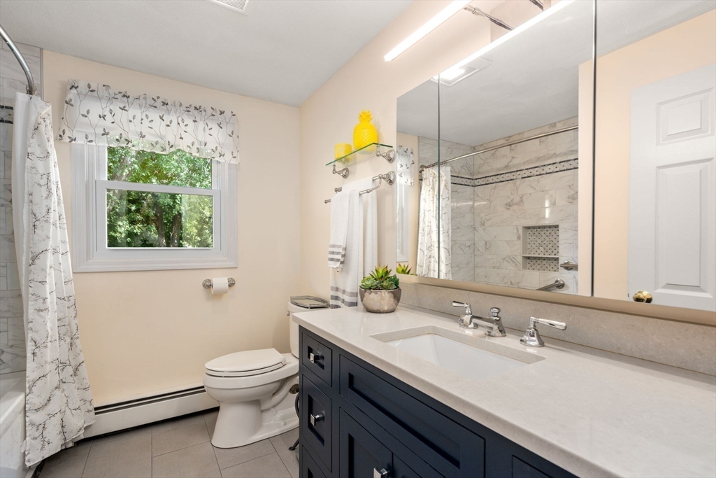 27 Prospect Avenue Arlington, MA 02476 - Photo 33 of 42 a bathroom with a granite countertop sink a toilet and a mirror