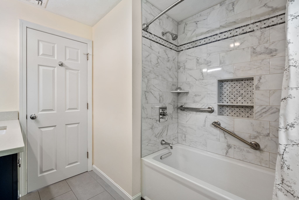 27 Prospect Avenue Arlington, MA 02476 - Photo 35 of 42 a bathroom with a bathtub and a shower