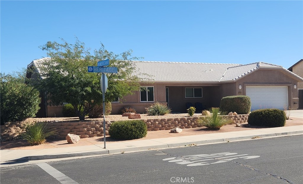 13237 Heritage Drive Victorville, CA 92392 - Photo 1 of 21 a front view of a house with a yard
