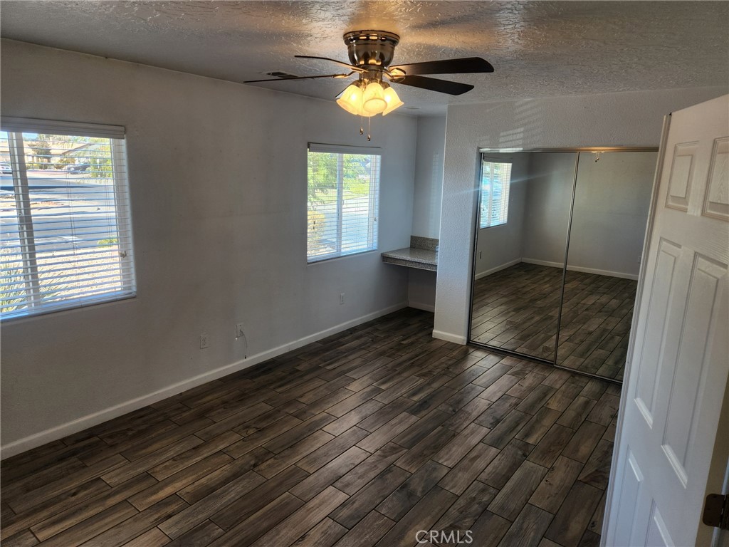 13237 Heritage Drive Victorville, CA 92392 - Photo 11 of 21 a view of an empty room with window and wooden floor