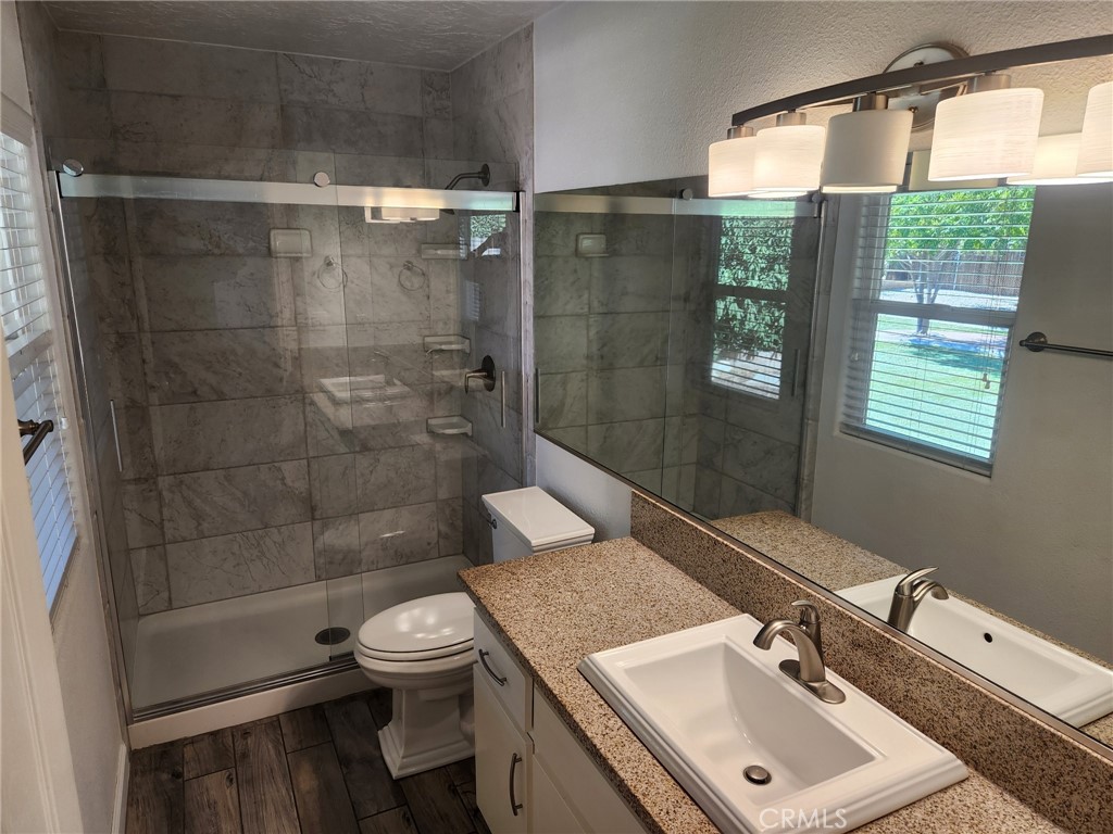 13237 Heritage Drive Victorville, CA 92392 - Photo 15 of 21 a bathroom with a sink toilet and shower