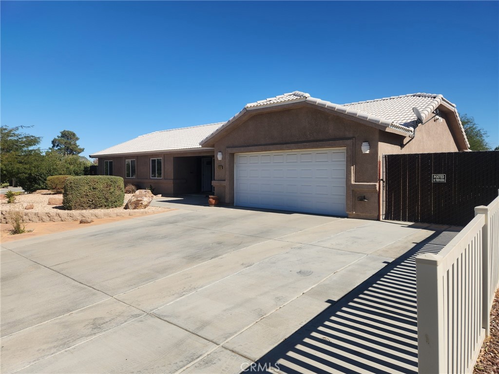 13237 Heritage Drive Victorville, CA 92392 - Photo 2 of 21 a front view of a house with a yard