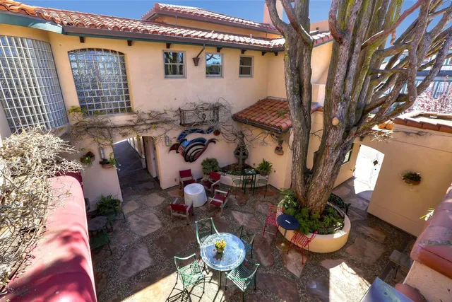 a view of a patio with chairs and potted plants