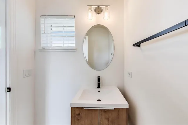 a bathroom with a sink a vanity and a mirror