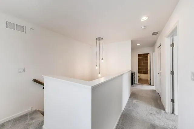 a view of a hallway with windows