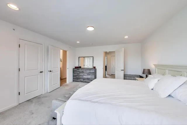 a large bedroom with a bed and a view of bathroom