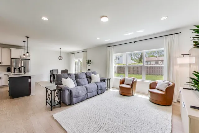 a living room with furniture and large windows