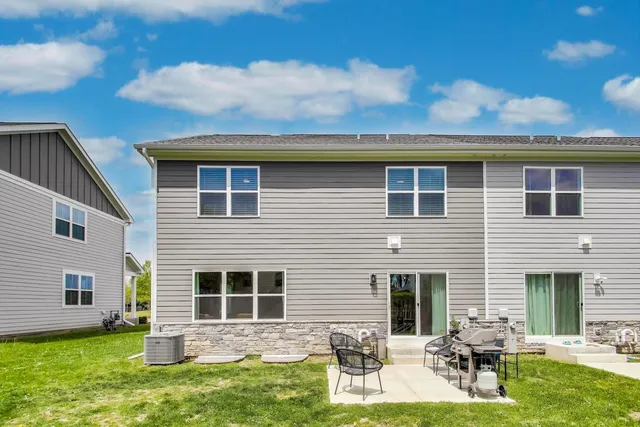 a front view of house with yard and outdoor seating