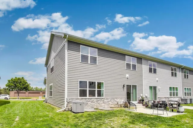 a backyard of a house with table and chairs