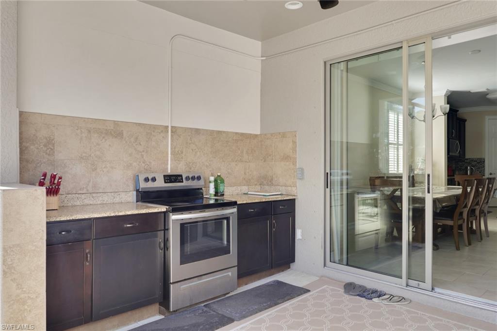 16309 Aberdeen Way Naples, FL 34110 - Photo 32 of 34 a kitchen with stainless steel appliances granite countertop a stove a sink and a refrigerator