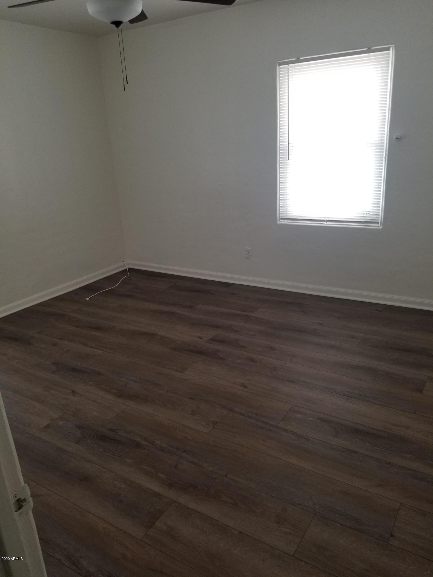 26 East Hatcher Road Phoenix, AZ 85020 - Photo 30 of 31 an empty room with wooden floor and windows