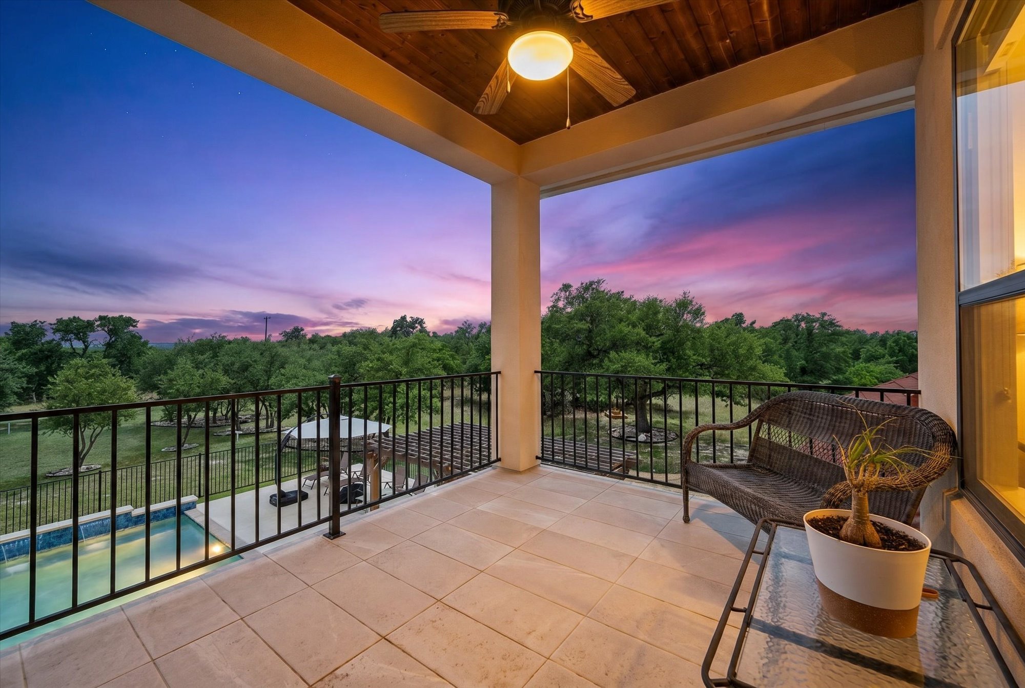 638 Strada Luca Florence, TX 76527 - Photo 21 of 38 An inviting covered patio offers panoramic views of the verdant landscape and a private swimming pool under a vivid twilight sky.