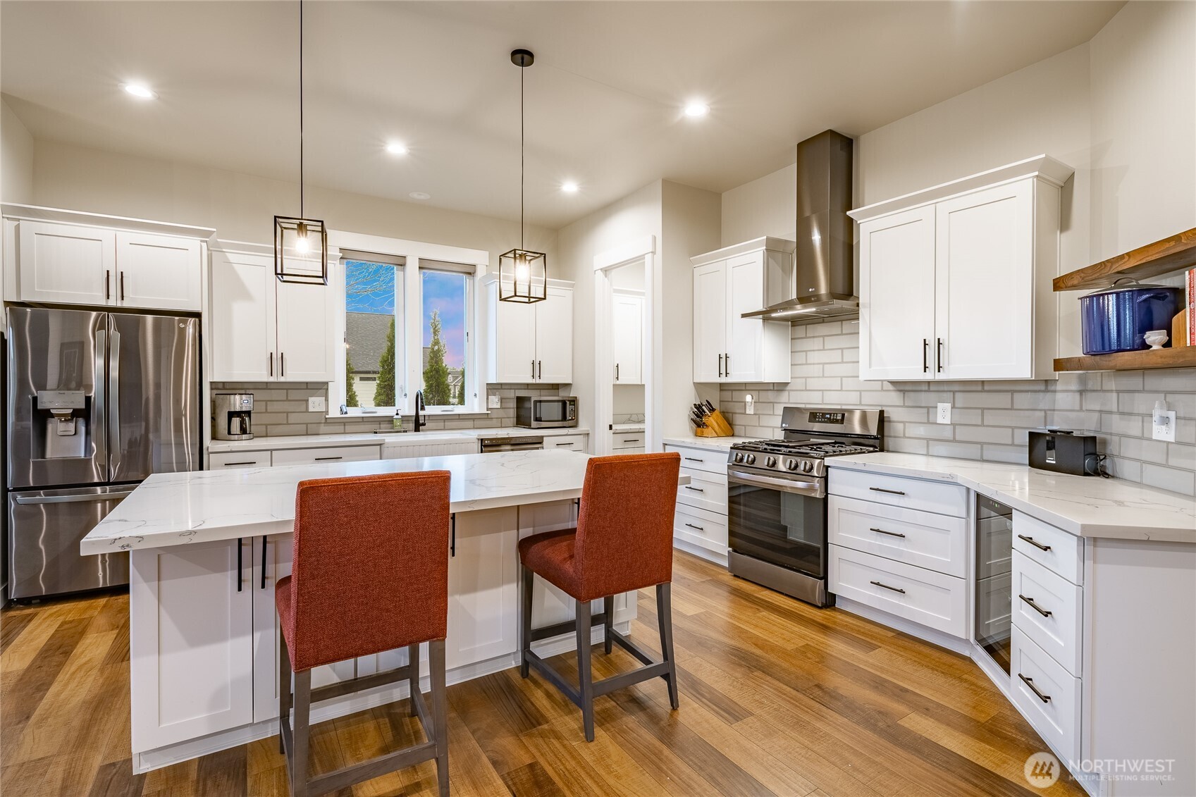2202 Berryman Loop Lynden, WA 98264 - Photo 16 of 39 a kitchen with stainless steel appliances granite countertop a sink a stove a refrigerator cabinets a dining table and chairs