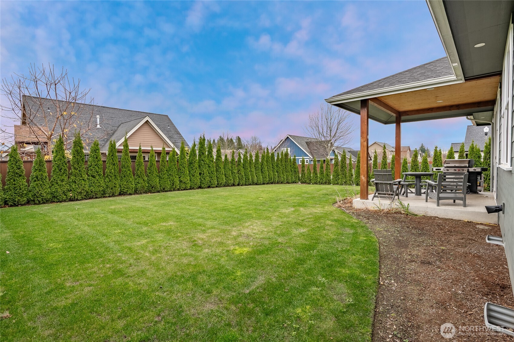 2202 Berryman Loop Lynden, WA 98264 - Photo 37 of 39 a view of a patio with a table and chairs under an umbrella