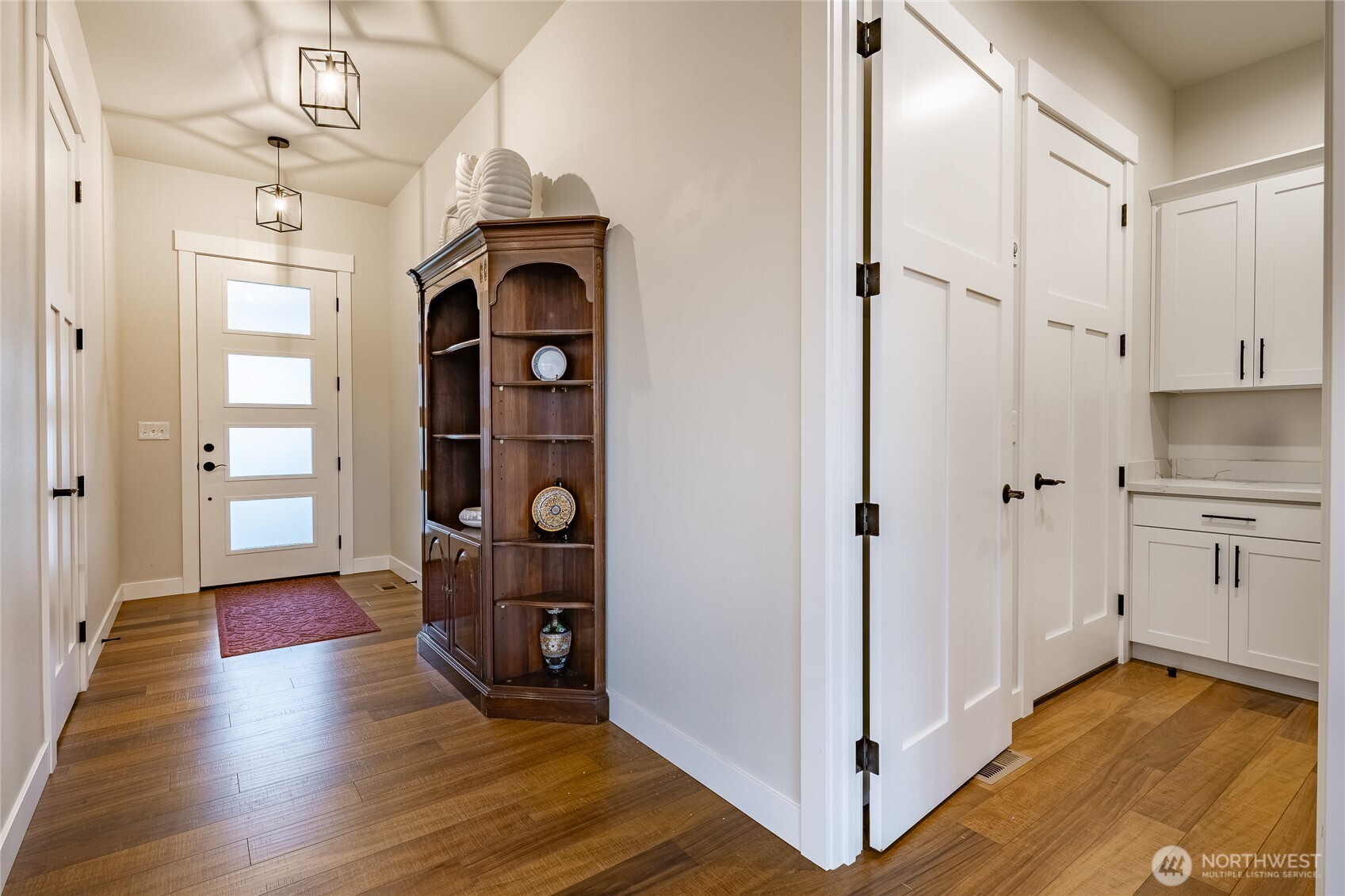 2202 Berryman Loop Lynden, WA 98264 - Photo 5 of 39 a view of a hallway with wooden floor and staircase