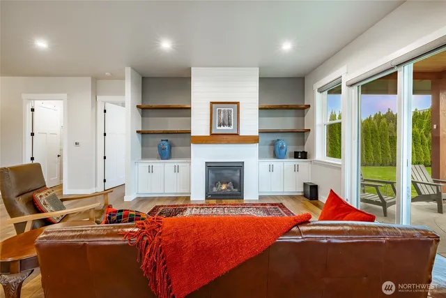 a living room with furniture a fireplace and city view