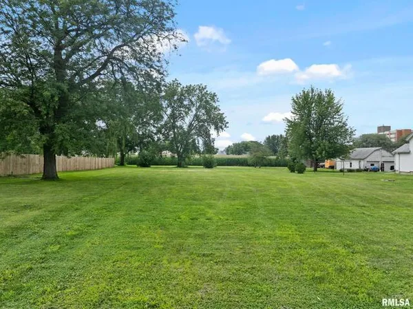 a view of grassy field with benches
