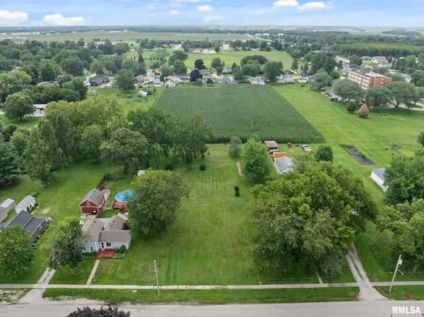 a view of a city with lush green forest