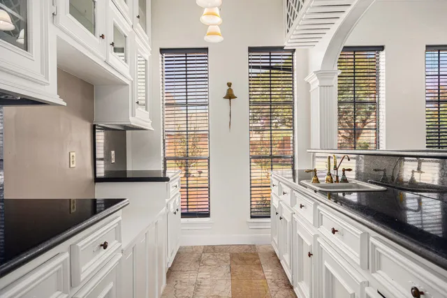 a kitchen with stainless steel appliances granite countertop a stove sink and cabinets