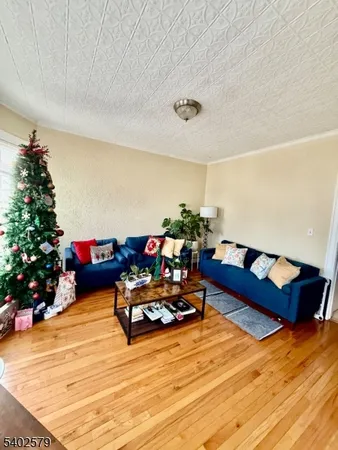 a living room with furniture and flowers