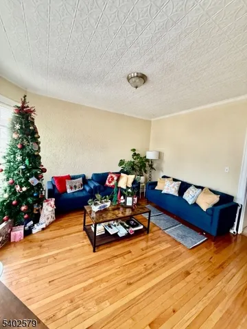 a living room with furniture and flowers