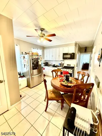 a living room with lots of furniture and kitchen appliances