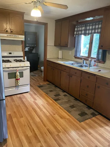 a kitchen with a stove a sink and a refrigerator