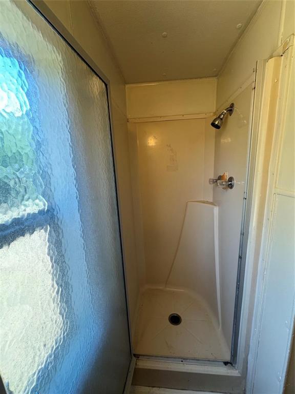 2014 Spring Court Azle, TX 76020 - Photo 8 of 16 a bathroom with a glass shower door