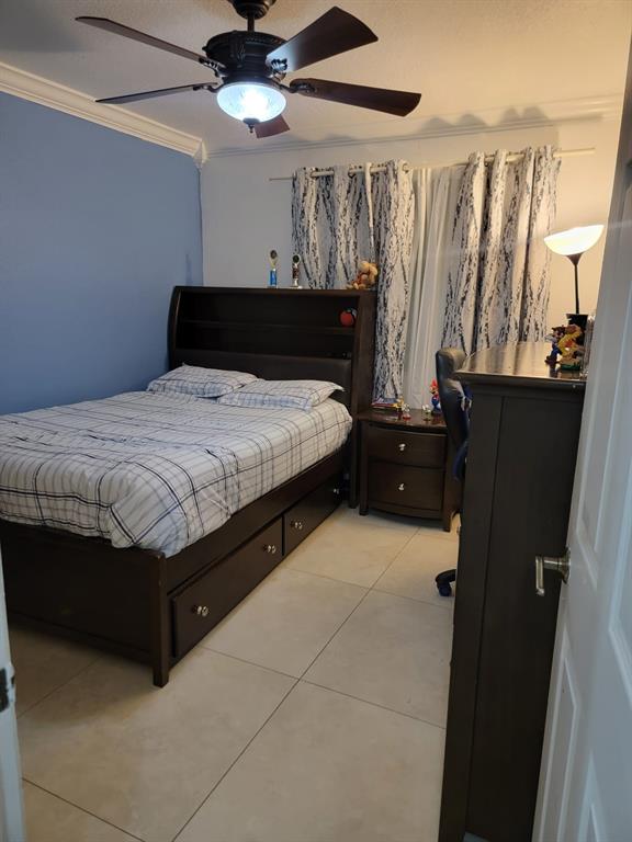 11821 Southwest 18th Street, Unit 223 Miami, FL 33175 - Photo 16 of 31 a bedroom with a bed and a chandelier