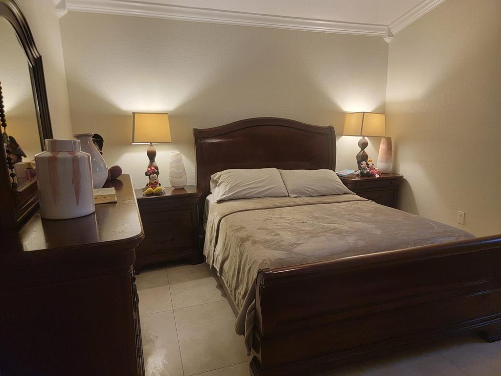 11821 Southwest 18th Street, Unit 223 Miami, FL 33175 - Photo 21 of 31 a bedroom with a bed and window