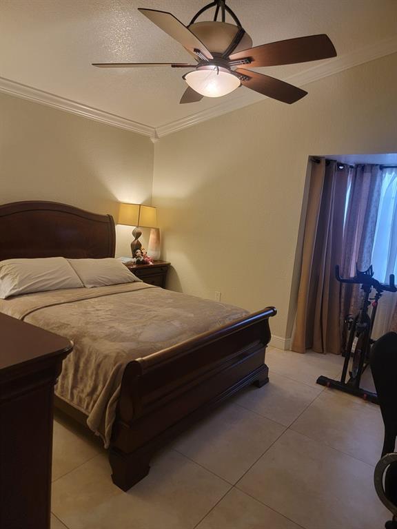 11821 Southwest 18th Street, Unit 223 Miami, FL 33175 - Photo 23 of 31 a bedroom with a bed and a chandelier