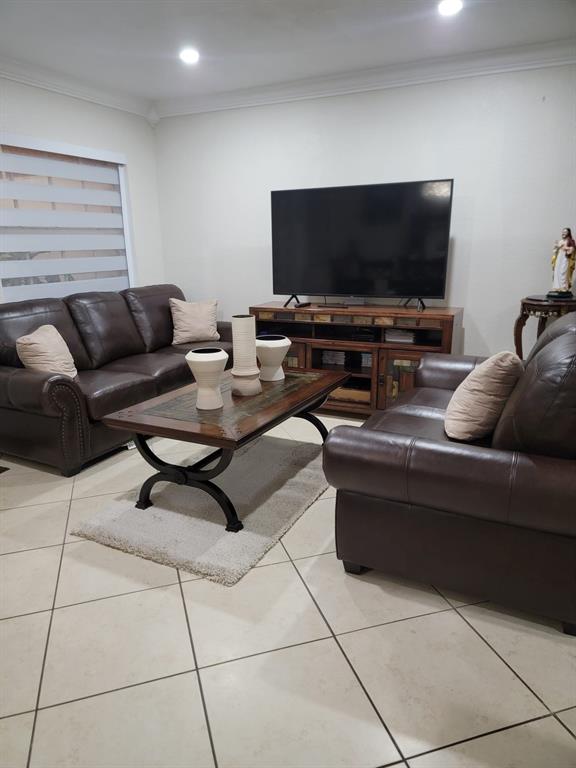 11821 Southwest 18th Street, Unit 223 Miami, FL 33175 - Photo 7 of 31 a living room with furniture and a flat screen tv