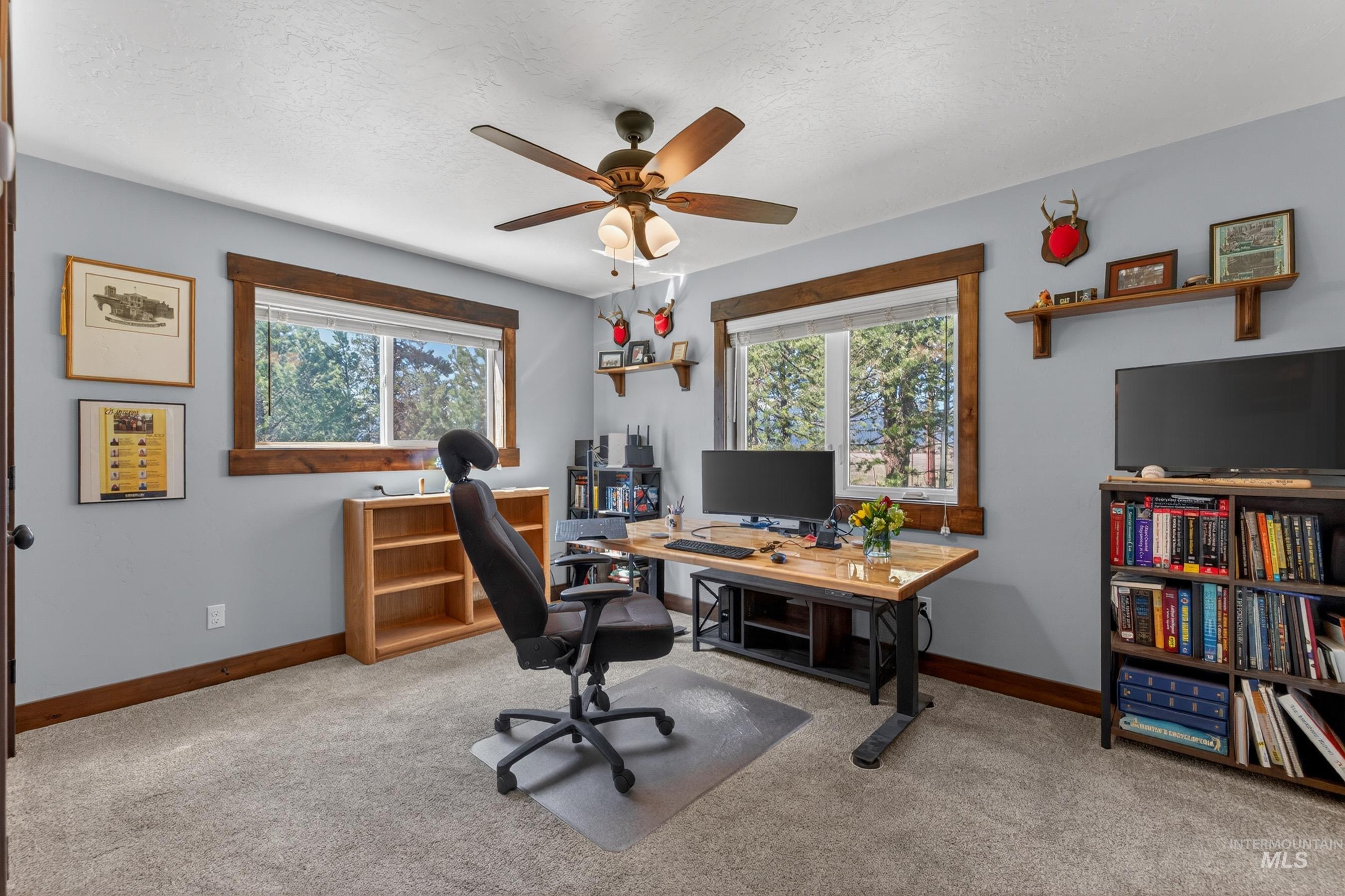 13388 Norwood Road McCall, ID 83638 - Photo 22 of 44 Room with light gray walls, plush gray carpeting, and two windows framed with wood-finish trim