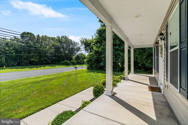 a view of a house with backyard and porch