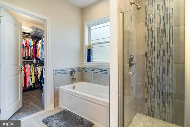 a bathroom with a bathtub and a shower