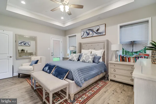 a spacious bedroom with a bed and a chandelier