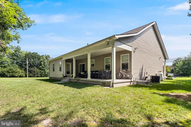 a view of a house with a yard and sitting area