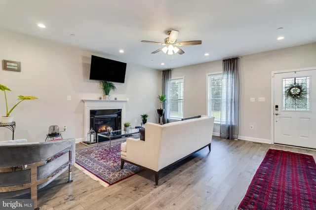 a living room with furniture fireplace and flat screen tv