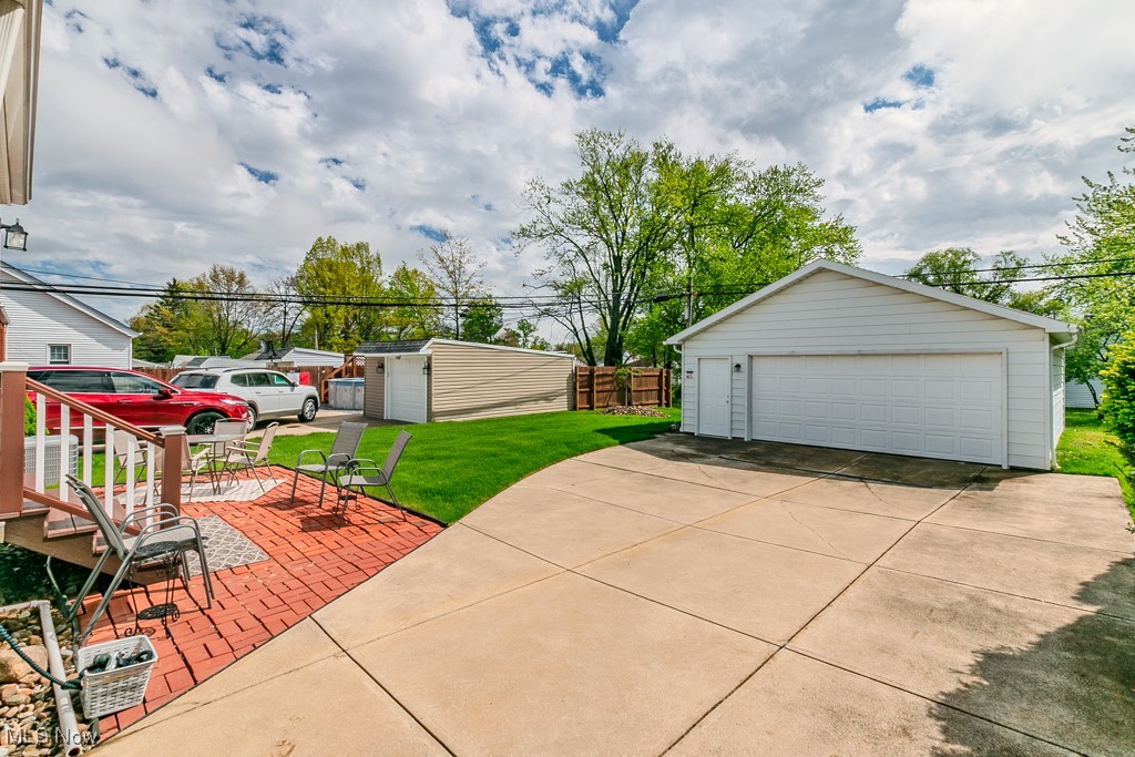 1237 Mayfield Ridge Road Cleveland, OH 44124 - Photo 36 of 38 Rear view of house with a lawn and a patio