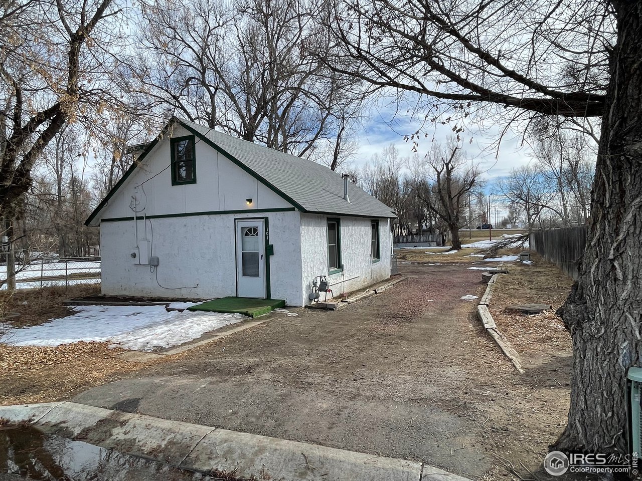 101 Reed Place Longmont, CO 80504 - Photo 1 of 34 a view of a house with a snow and tree