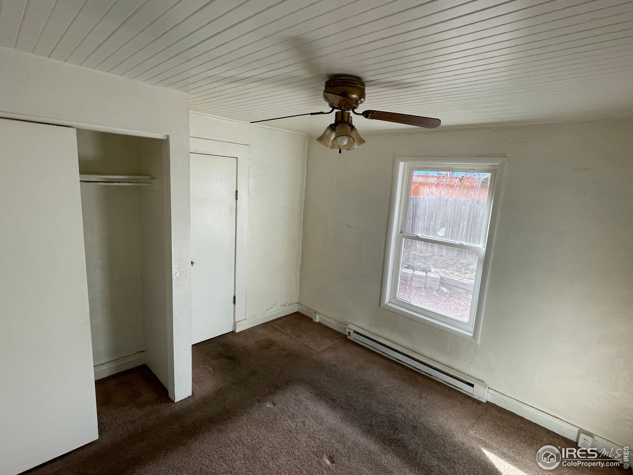 101 Reed Place Longmont, CO 80504 - Photo 19 of 34 an empty room with windows and fan
