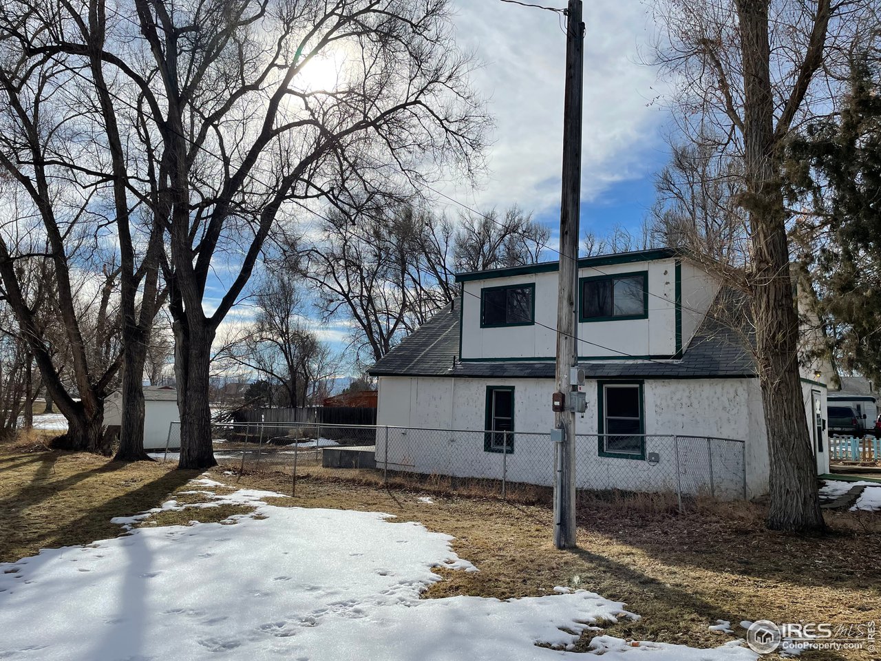 101 Reed Place Longmont, CO 80504 - Photo 31 of 34 a view of a blue house with snow on the road
