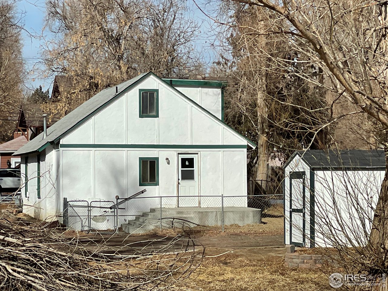 101 Reed Place Longmont, CO 80504 - Photo 5 of 34 a view of a white house next to a yard with wooden fence